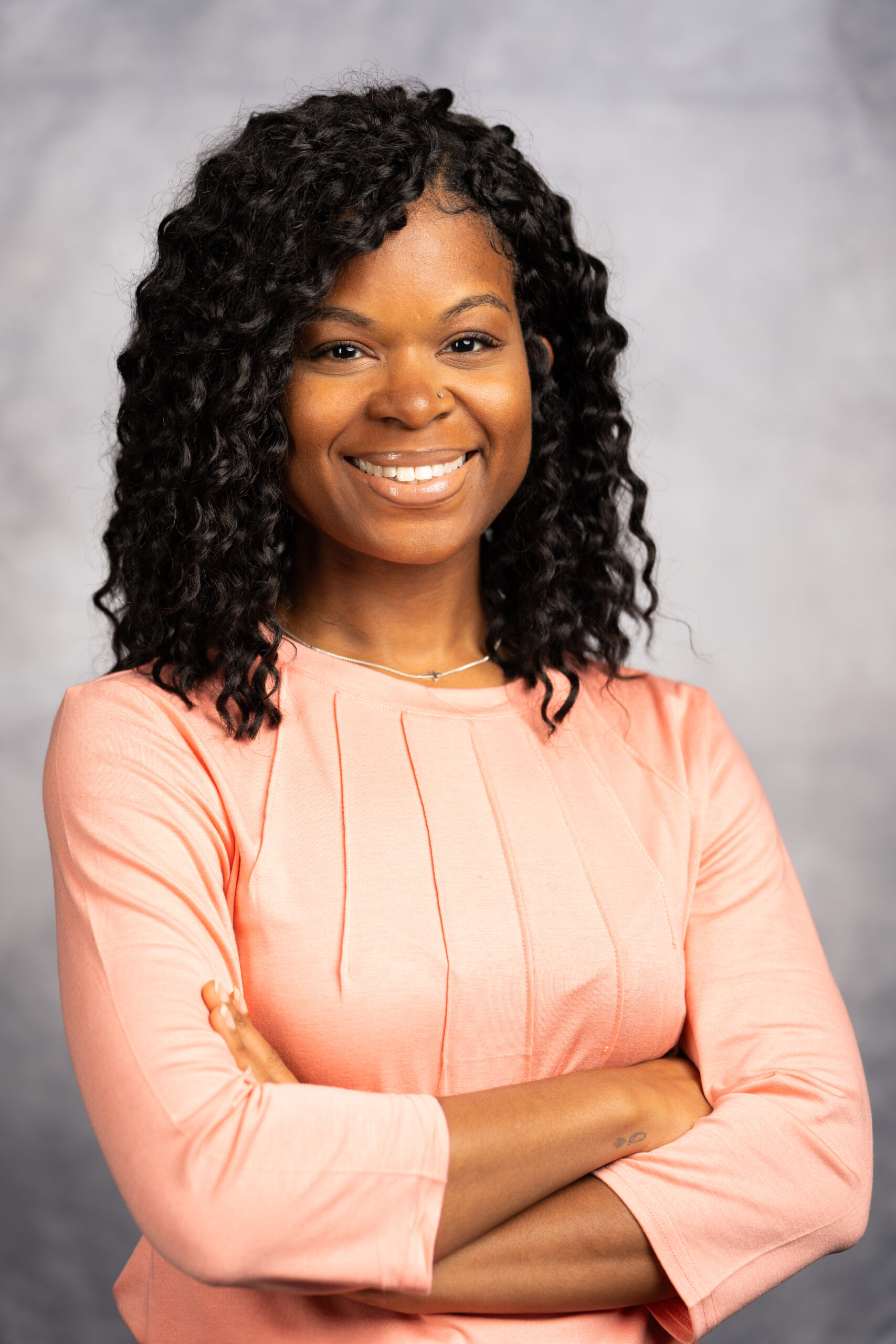 Dr. Janet Kinney, doctor at Mansfield Pediatrics, PLLC, wearing a black shirt with a growing child on it.