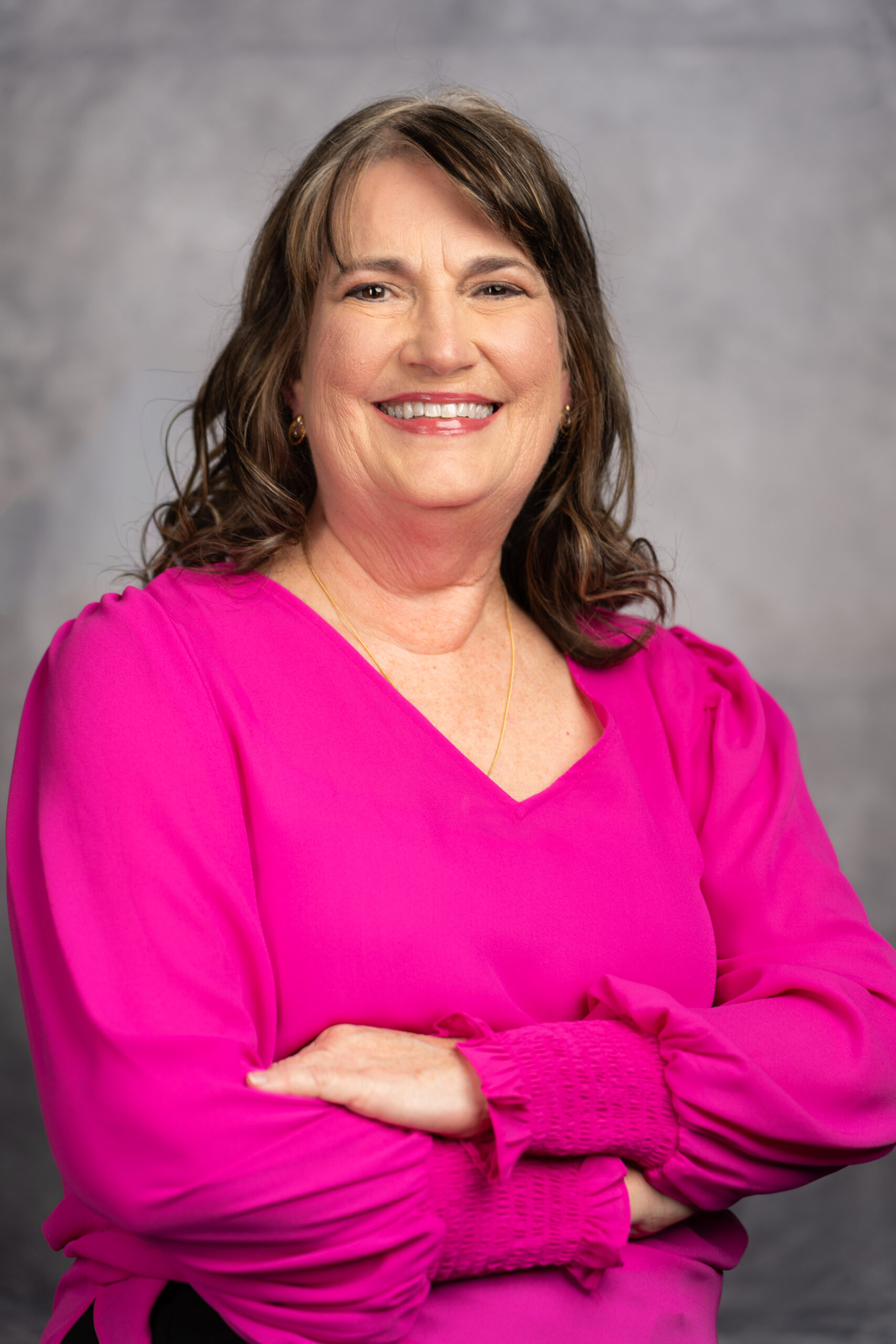 Dr. Janet Kinney, doctor at Mansfield Pediatrics, PLLC, wearing a black shirt with a growing child on it.