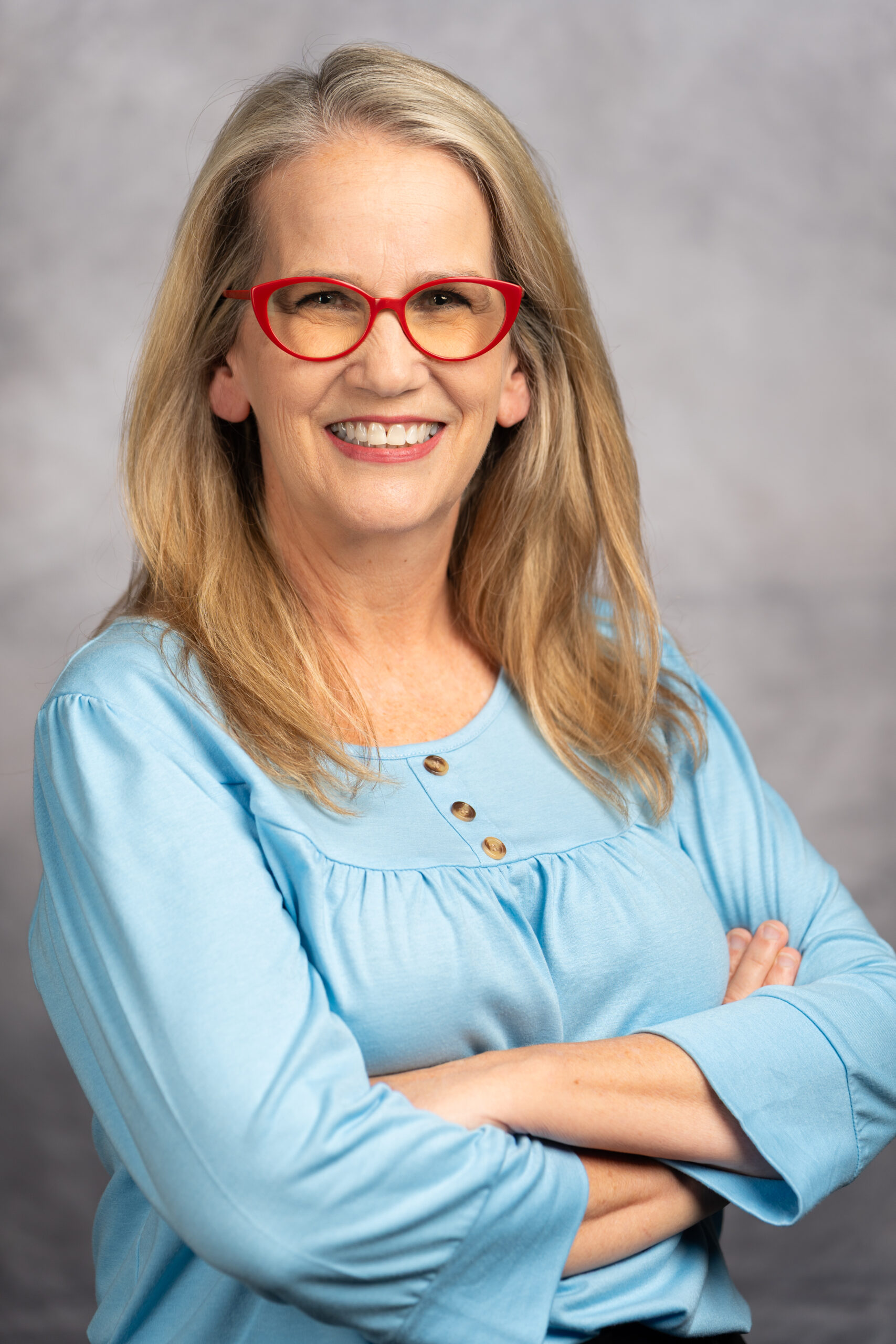 Michelle O'Connor, doctor at Mansfield Pediatrics, PLLC, wearing a black shirt with a growing child on it.